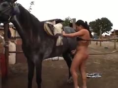 When eager and desperate for sex, a naked amateur milf works the horse dick with both hands.